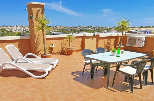 Orihuela Costa Apartment | Apartment with Large Roof Solarium, Pool, Garden, Barbecue, A/C & Wi-Fi