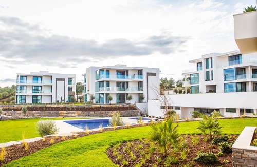 Vila Nova De Cacela Apartment | Heated pool, lush gardens, and air conditioning at Monte Rei.